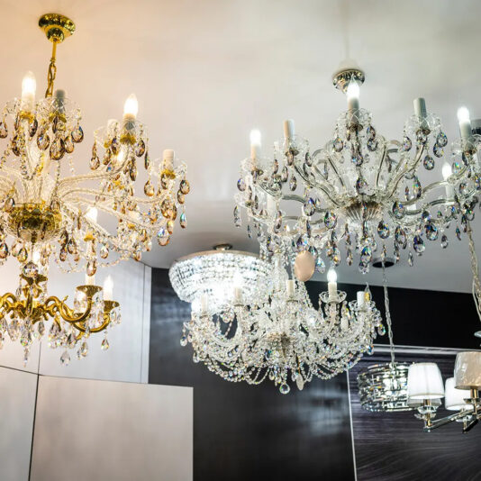 Luminous crystal chandeliers on the ceiling in a shop window